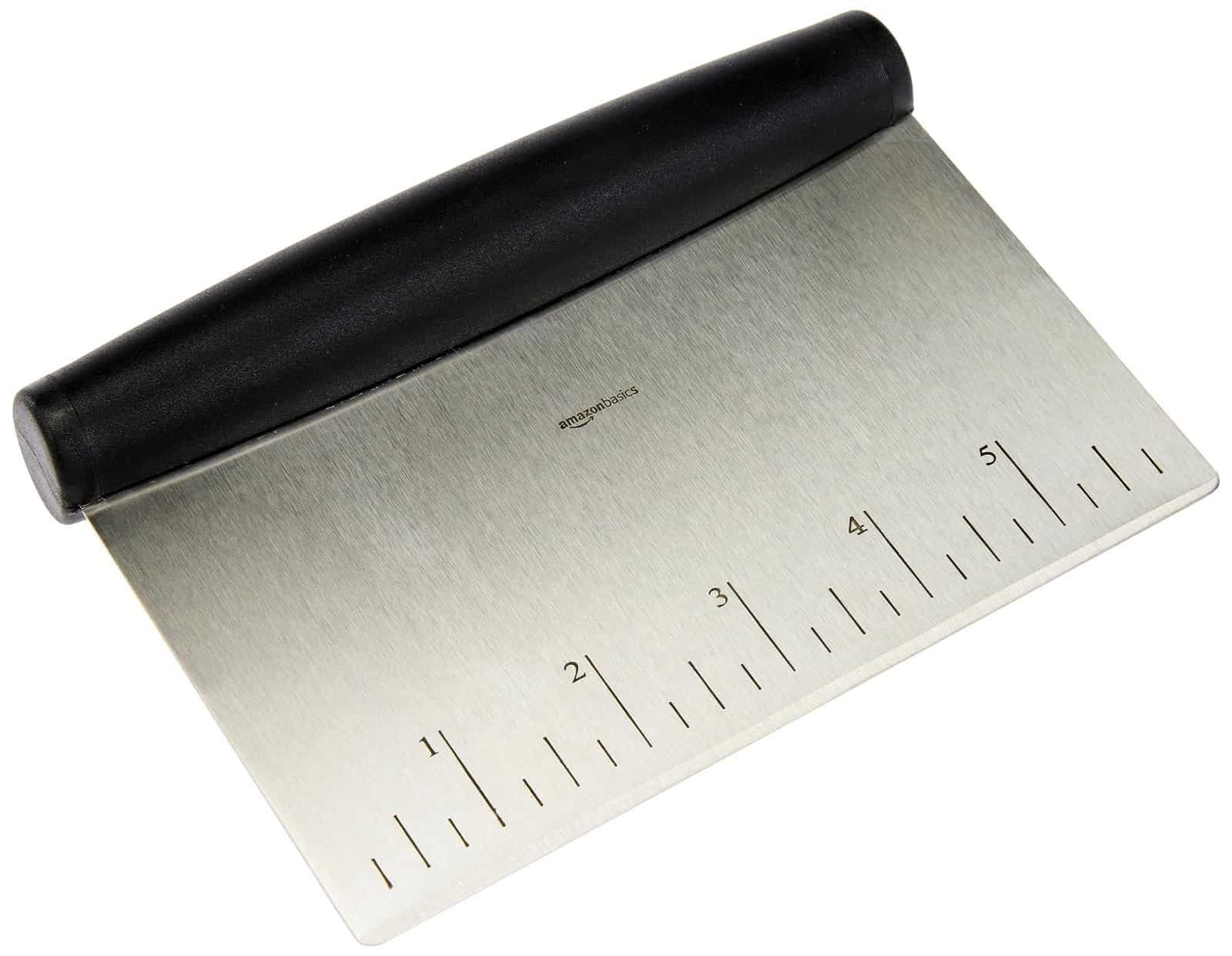 Stainless steel scraper tool on professional kitchen counter